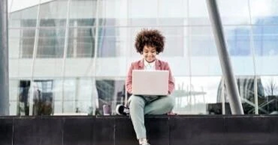 Woman using laptop outdoors